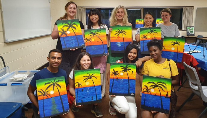 Students with painting of Darwin sunset