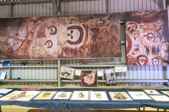 Copies of archival materials exhibited at the Wilinggin Shed in July 2022 with portraits in front and prints of rock art copies in the back
