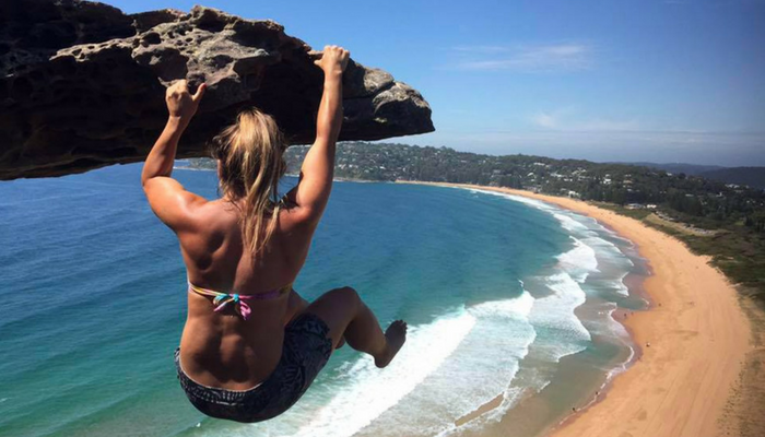 Adventurous Bridie hangs off a cliff face 