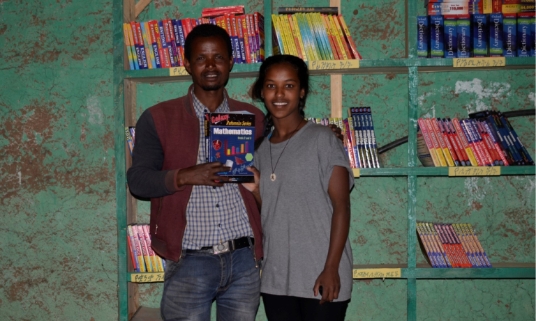 Etabez with textbooks purchased for the local school in her rural Ethiopian village through Birtukan's Project