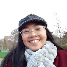 Angelina Aquino - young filipino woman smiling wearing glasses, cap and scarf