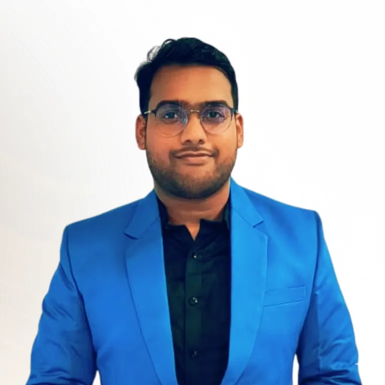 Man wearing glasses and blue blazer smiling at camera