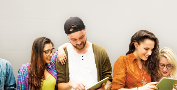 A group of people smiling and reading a pamphlet