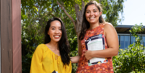 Two female international students smiling