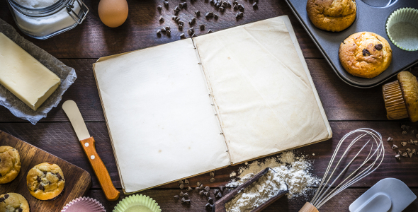 Open book surrounded by baking materials