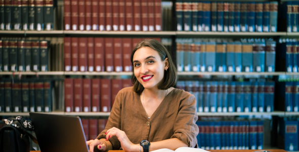 Yuliia Shchedrovska studying in library 