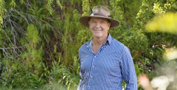 Prof Stephen Garnett head and shoulders, wearing hat with green leafy background