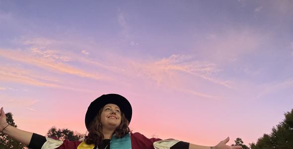 Alana Gall Graduation photo in front of sunset