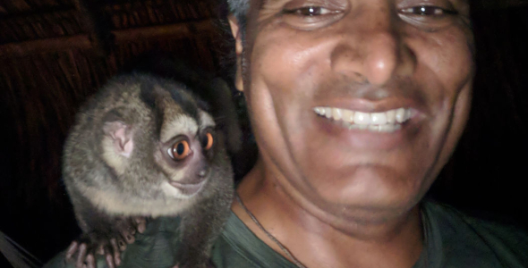 Professor Sunil Kadri, head and shoulders, with a small furry animal on his right shoulder