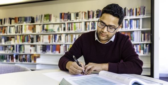 CDU Student in library