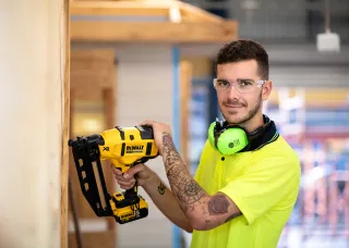 male apprentice using a power tool
