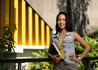 MBA student Ellie holding book on campus