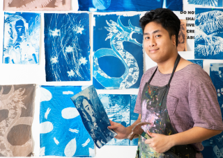 Creative arts student with artworks