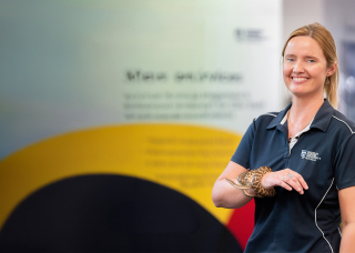 Megan from CDU Alice Springs holding a snake