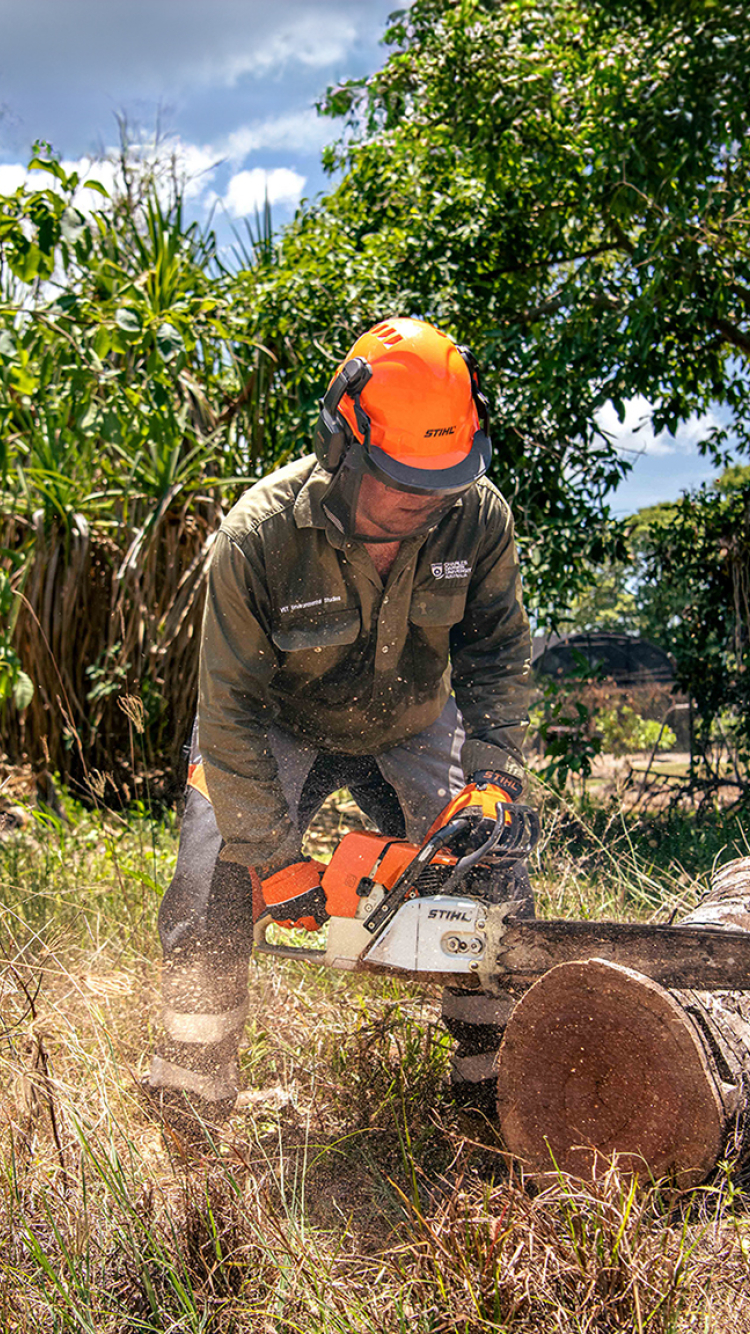 Person operating a chainsaw