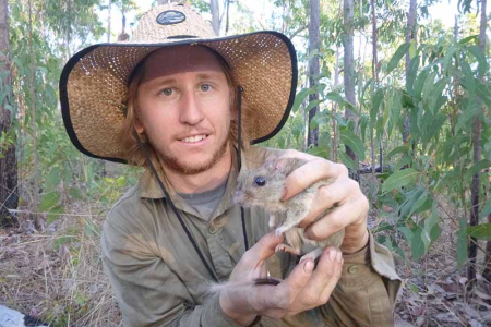 Small mammal researcher Hugh Davies holds a brush tailed rabbit rat.