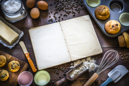 Open book surrounded by baking materials