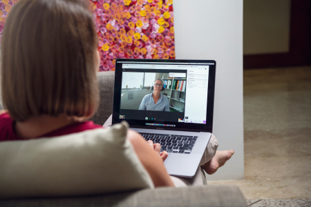 Woman studying online with nurse on video