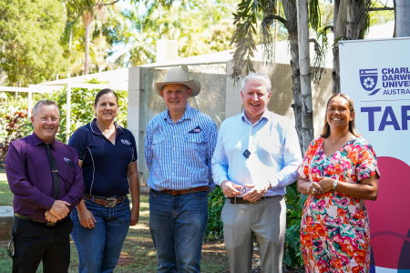 group of people standing in front of CDU TAFE sign