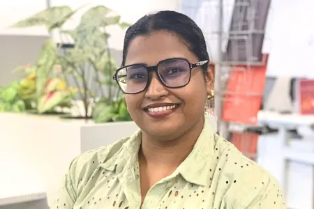 Image of a girl sitting in a green shirt