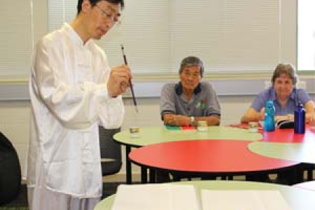 Confucius Institute Chinese Co-Director Mr Donghe Liu conducts a calligraphy demonstration