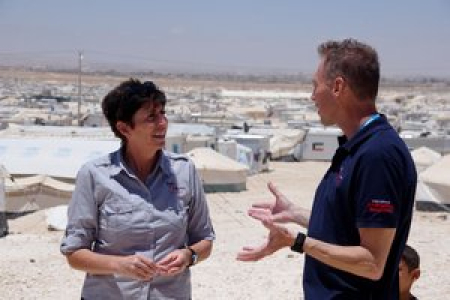 Emma Kettle with RedR Australia electrical engineer John Simpson in front of a section of Za’atari refugee camp