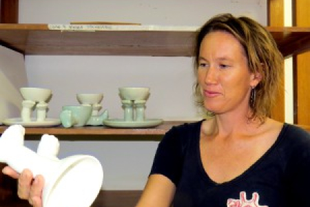 Mel Darr inspects one of her ceramic pieces included in “The Some of Us” student art exhibition at Araluen Arts Centre.