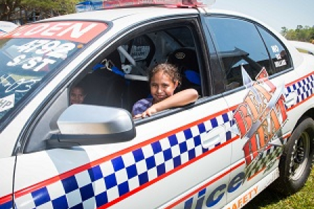 Amelia Kadiba checks out the “Beat the Heat” road safety police racing car at last year's CDU Open Day