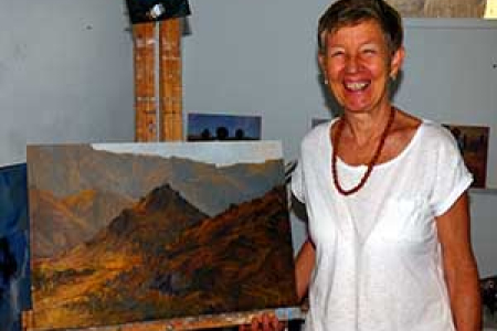 Ms Taylor with one of the landscapes in the “Portraits of Country” exhibition.