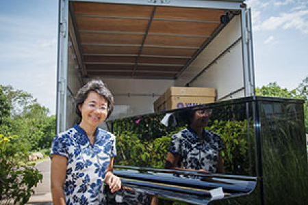 CYCM Acting Director Chen Hui oversees the arrival of the new polished ebony pianos.