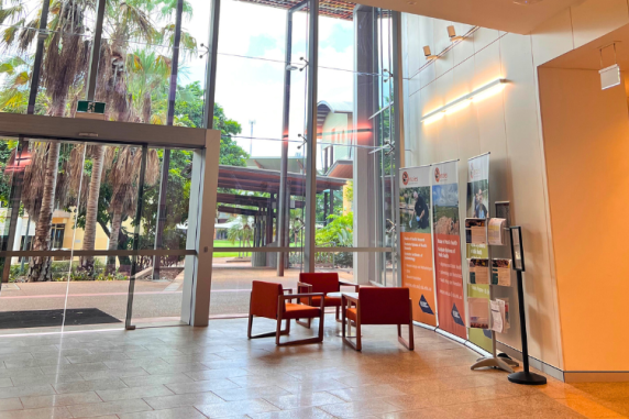 foyer of Menzies Building Red 9 at Campus - large internal building with glass windows and orange chairs