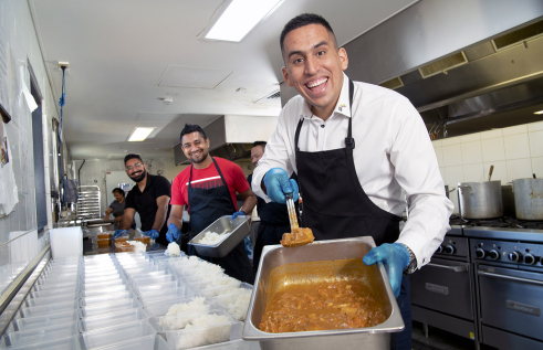 CDU’s International Student Support Project Officer Ben Poveda-Alfonso helps prepare meals for the Kindness Shake.