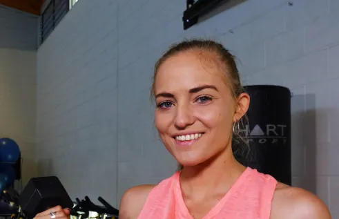 CDU student Suzanne Van Engelenhoven holds a dumbbell