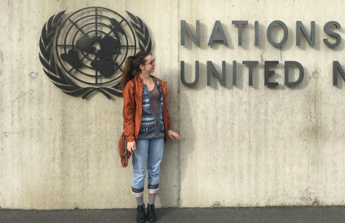 CDU student Stephanie von Kanel standing in front of a United Nations sign. 