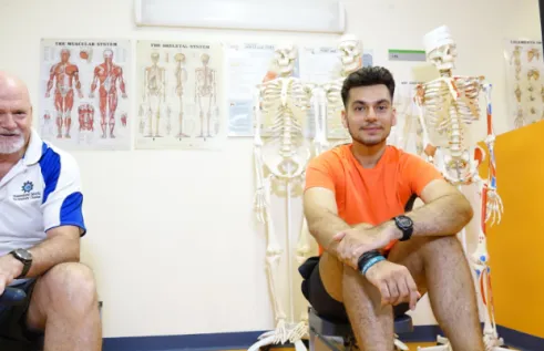 Emmanuel sitting in an exercise science class