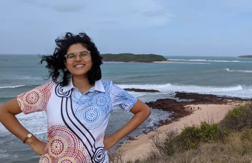 Harita smiling in front of a view of the ocean
