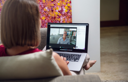 Woman studying online with nurse on video