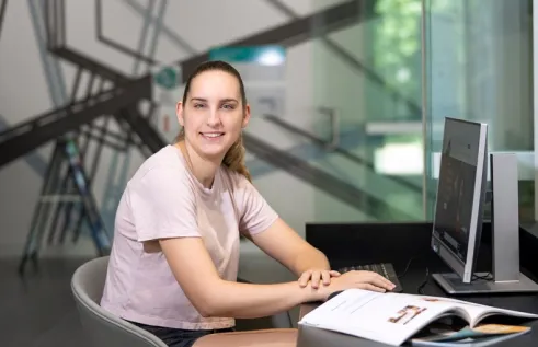 CDU student Zoe White sitting at a computer the Waterfront campus