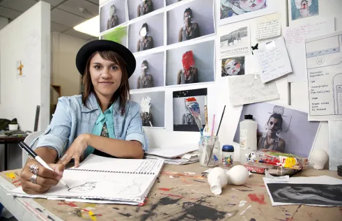 Creative arts student drawing in workshop