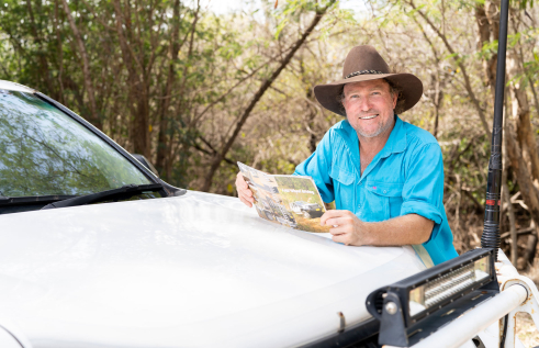 Conservation and ecosystem management lecturer next to a 4wd vehicle