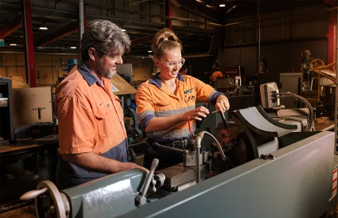 Trades student with supervisor in workshop