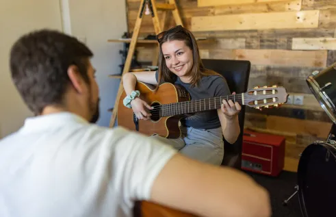Music student playing guitar