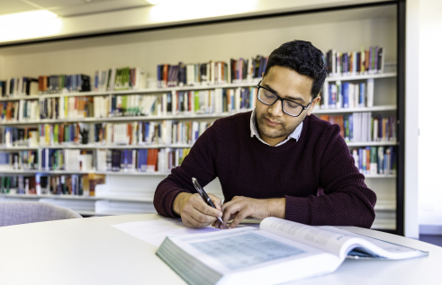 CDU Student in library