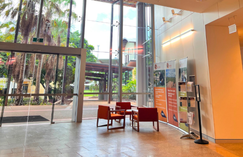 foyer of Menzies Building Red 9 at Campus - large internal building with glass windows and orange chairs