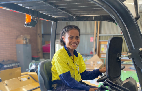 female apprentice sitting in equipment