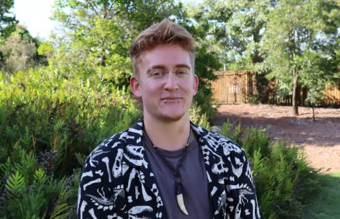 Kade Skelton head and shoulders, with trees and greenery in the background