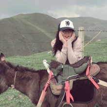 Chengxi Li sitting on a donkey