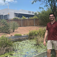 Matthew standing in front of a pond