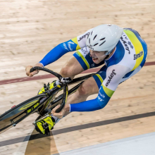CDU student Jacob Schmid cycling on an indoor track