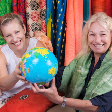 Enterprising women holding the world globe and smiling